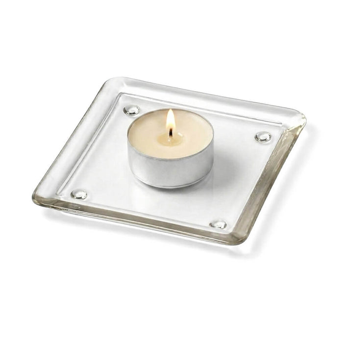 Lit tea light candle on a 5" glass pillar plate