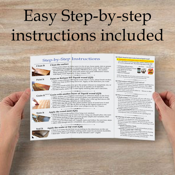 Hands holding an instructions book for Retique It White Wash Smooth Finish Kit, a wood finishing product.