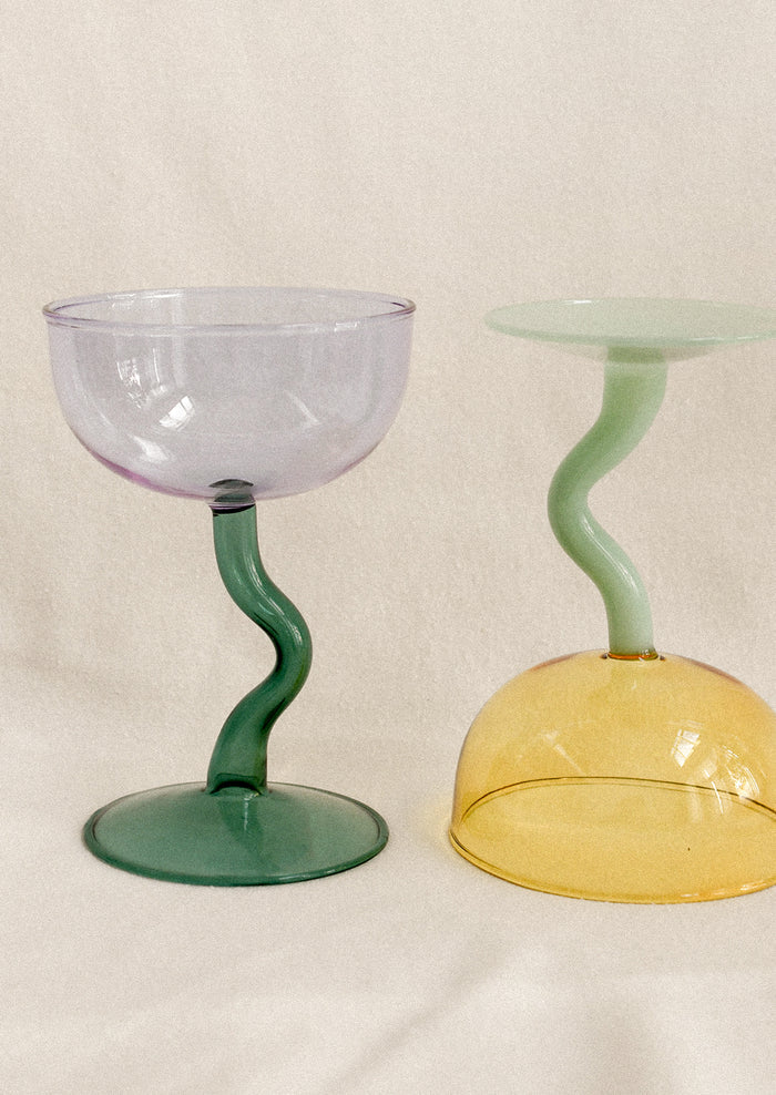 Coupe glasses with squiggle shaped handles.