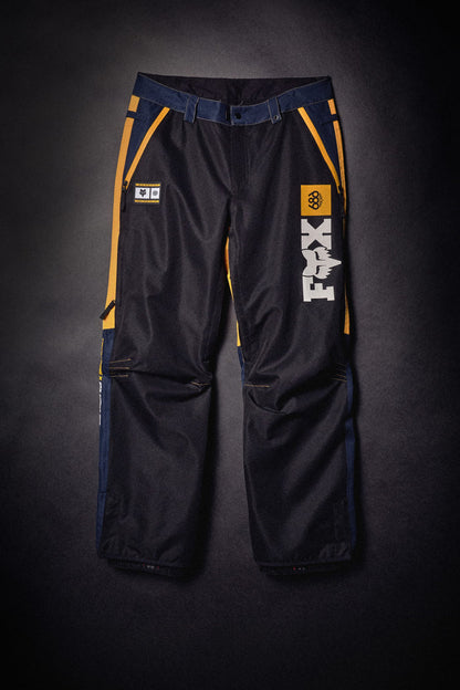 686 Men’s Fox Racing Spec Shell Pant in waterproof polyester with yellow and navy accents and leg logos.