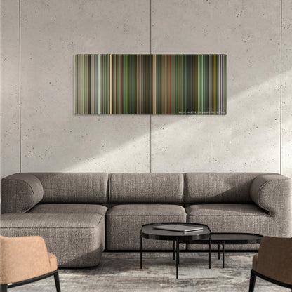 Dredd color palette canvas on a concrete wall above a gray sectional sofa