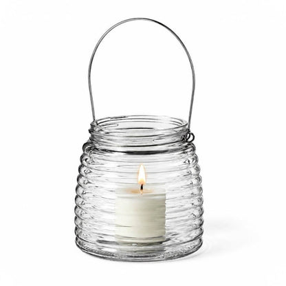 Lit white votive candle in a 4.6" Hanging Horizontal Ribbed Glass Jar with Handle