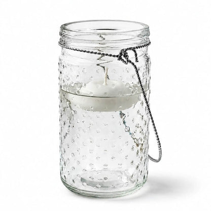7.5 inch hanging dotted glass jar with handle and a floating candle inside