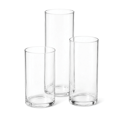 Three empty cylindrical glass vases of varying heights
