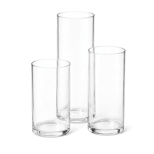 Three empty cylindrical glass vases of varying heights