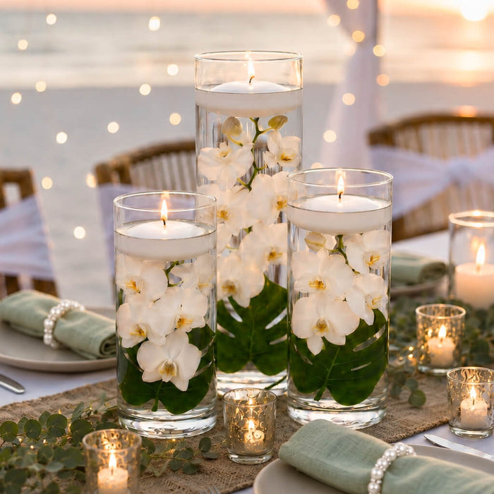Three cylinder vases with submerged white orchids and floating candles