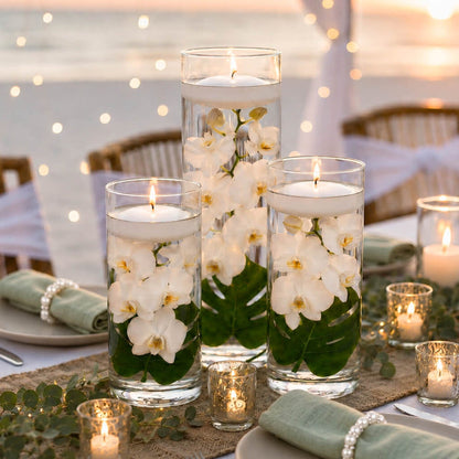 Three cylinder vases with submerged white orchids and floating candles