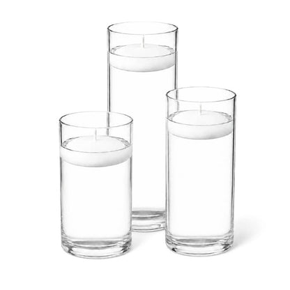 Floating white candles in glass cylinder vases
