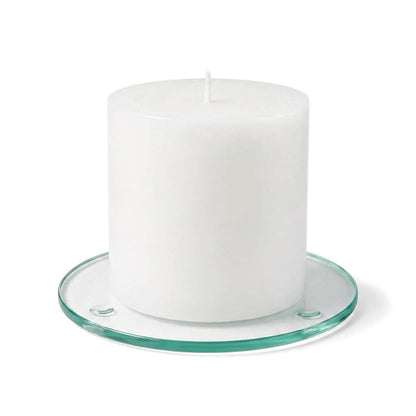 An unlit white pillar candle on a clear glass Round Coaster 4" against a white backdrop