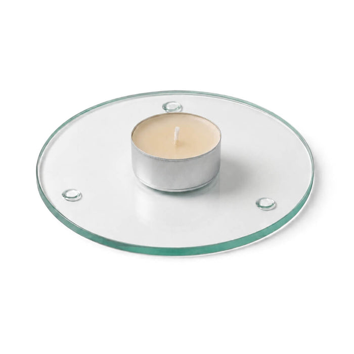 An unlit tealight candle on a clear glass Round Coaster 4" against a white backdrop