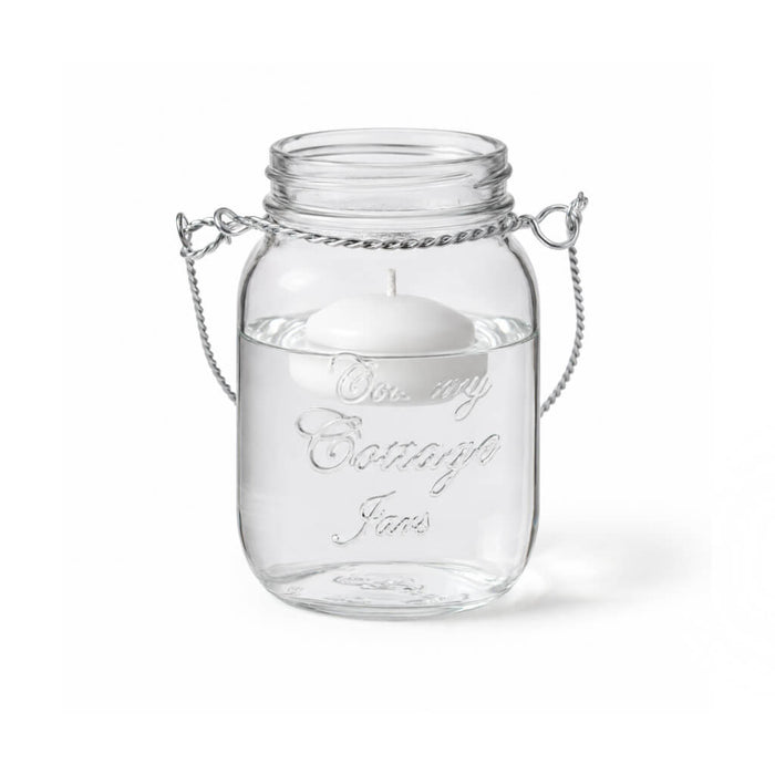 A Small Mason Jar with Handle and floating white candle