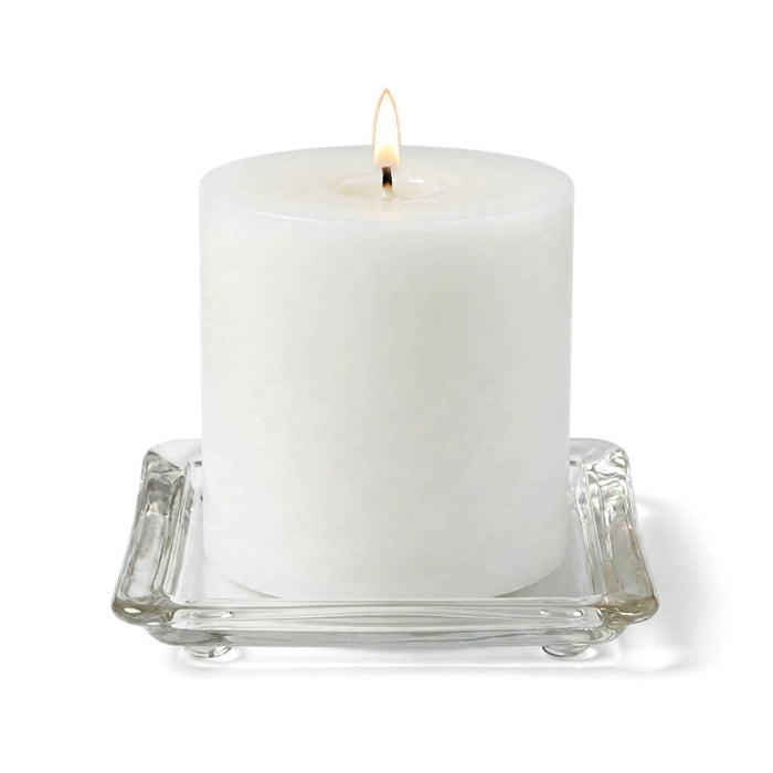 Lit candle on a 5" glass pillar plate