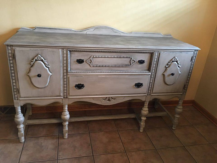 Retique It Dove Grey furniture and cabinet paint in a quart, showing a smooth, painted wood surface with a matte finish.