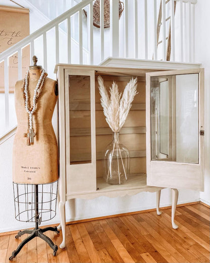 Retique It furniture and cabinet paint in French Beige, shown on a vintage cabinet with the open quart can visible.