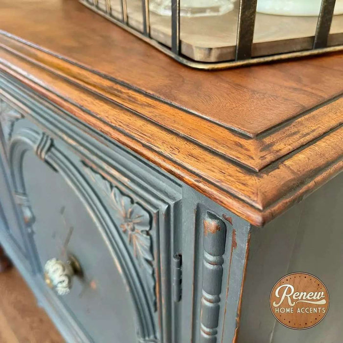 Retique It Gothic Grey furniture and cabinet paint in a quart, shown on a corner buffet highlighting smooth, matte finish.