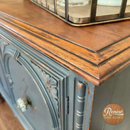 Retique It Gothic Grey furniture and cabinet paint in a quart, shown on a corner buffet highlighting smooth, matte finish.