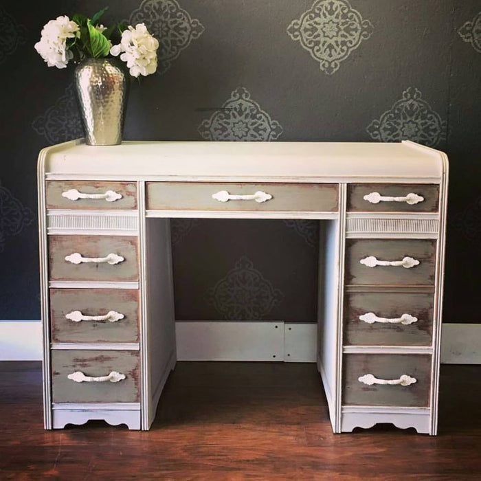 Retique It Meadow Path furniture and cabinet paint in a quart container, showing a smooth, painted wood surface with a soft green finish.