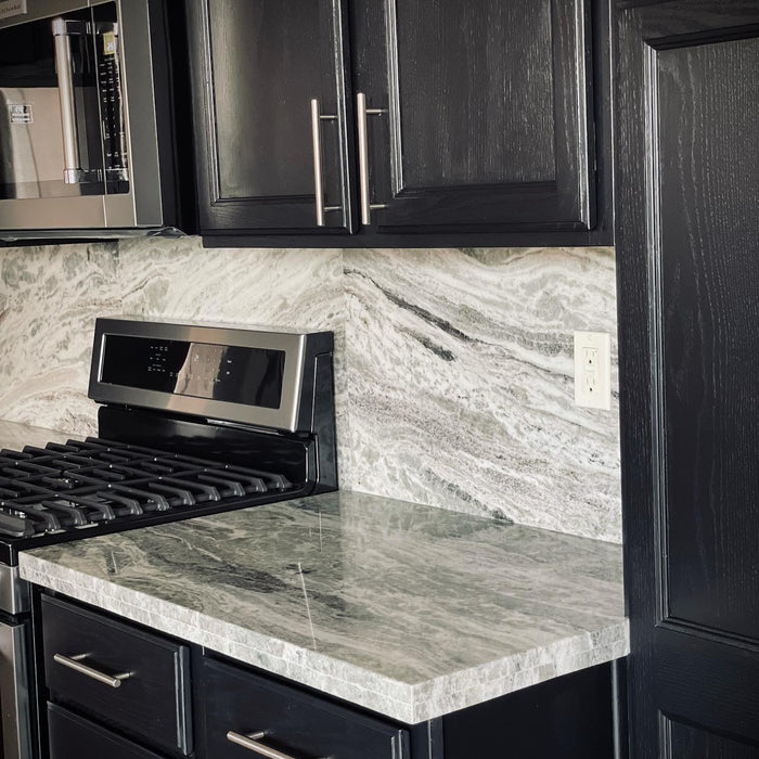 Retique It quart furniture and cabinet paint in midnight black, showing a painted kitchen cabinet with a smooth finish.