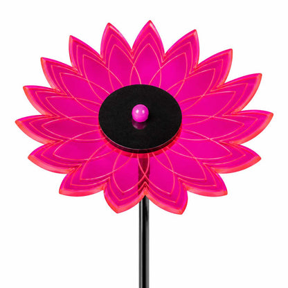 A bright pink translucent flower-shaped garden stake with a black circular center and a small pink ball, shown on a white background.
