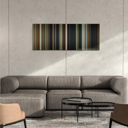 Hereditary color palette canvas on a concrete wall above a gray sectional sofa