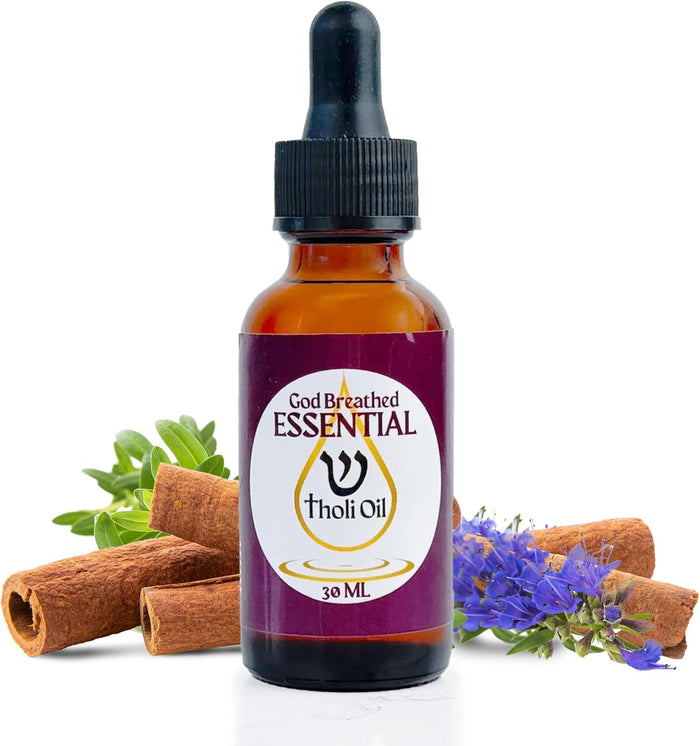 Essential oil bottle labeled 'Holy Anointing Tholi Oil' with cinnamon sticks and flowers on a white background