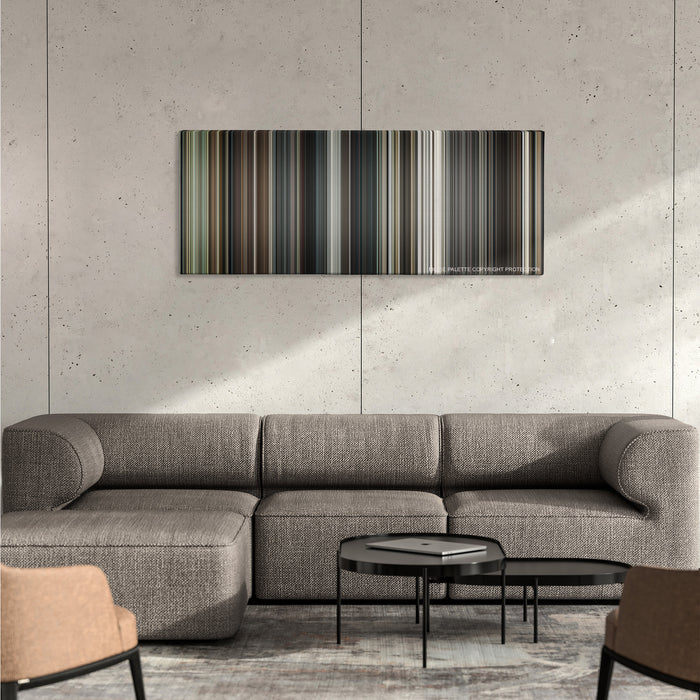 Interstellar color palette canvas on a concrete wall above a gray sectional sofa