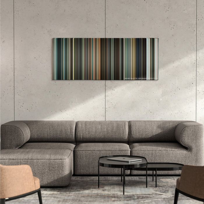 Jumper color palette canvas on a concrete wall above a gray sectional sofa