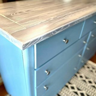 Retique It Liquid Wood 16oz bleached interior paint applied to a dresser with a natural wood finish and distressed design.