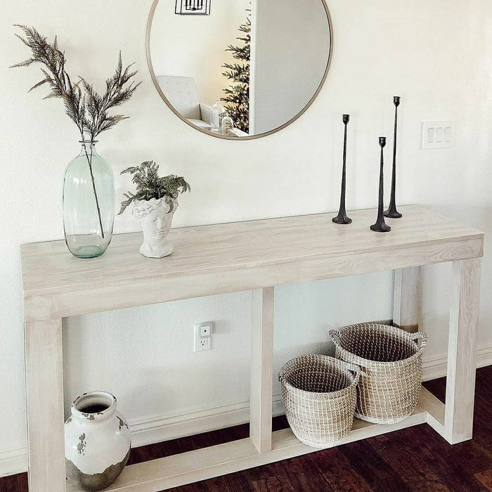 Liquid Wood interior paint in bleached finish by Retique It, shown on a table with a sage green tone and wood grain texture.