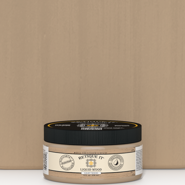 Retique It Liquid Wood 8oz light interior paint jar placed in front of a color swatch, showcasing natural wood finish and paint texture.