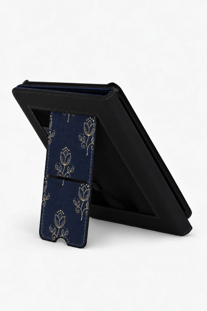 A black tablet folio case with a kickstand, shown open on a white background. The front cover features a dark navy blue flap with a gold floral pattern.
