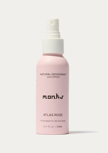 Pink deodorant spray bottle labeled 'mons' on a white background