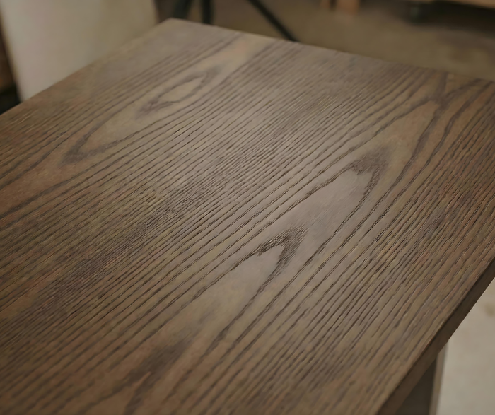 Close-up of a wooden surface with visible grain and texture.