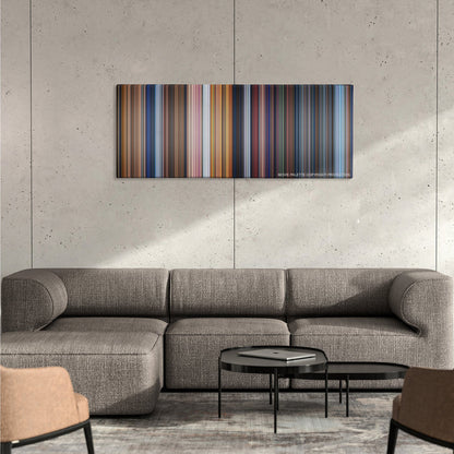 Pinocchio color palette canvas on a concrete wall above a gray sectional sofa