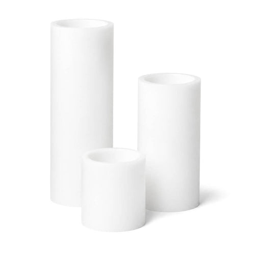 Set of three white LED pillar candles on a white background