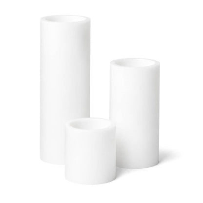 Set of three white LED pillar candles on a white background