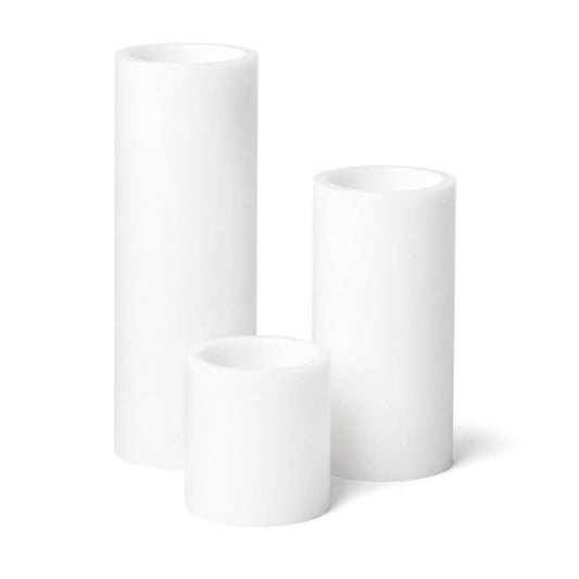 Set of three white LED pillar candles on a white background