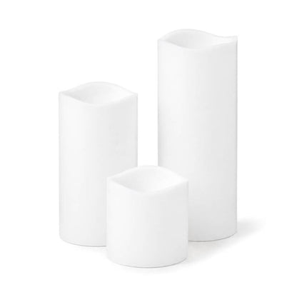 Three different size white Flameless LED Wavy Top Pillar Candles on white background