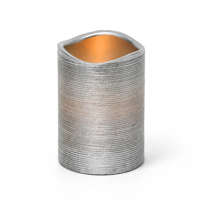 Silver Metallic Wavy Top LED Candle with warm glow on white background