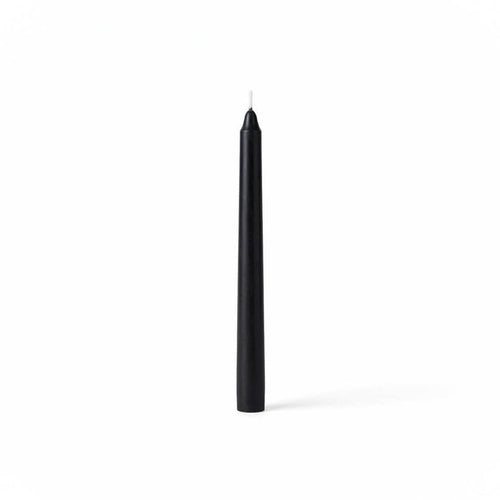 Single black taper candle on clean white backdrop