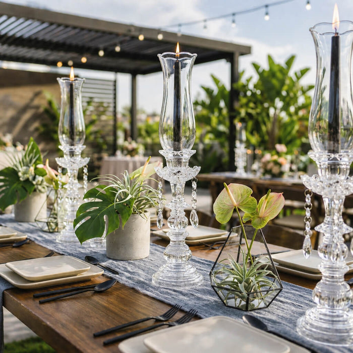 Black taper candles in crystal holders with tropical table decor