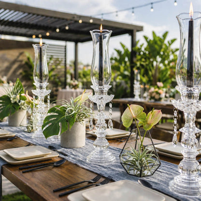 Black taper candles in crystal holders with tropical table decor