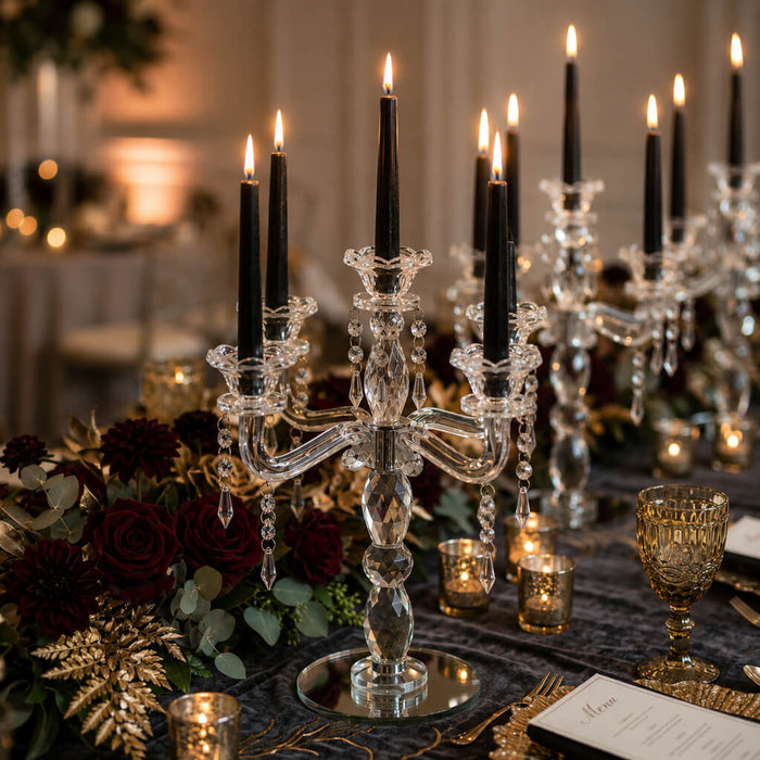 Luxurious crystal candelabra with lit black candles and roses