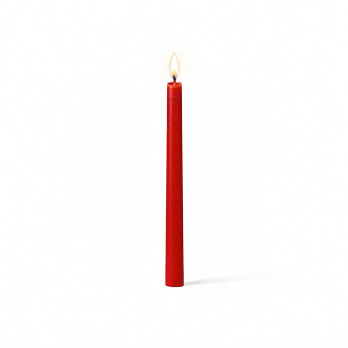 Red lit taper candle standing on white background
