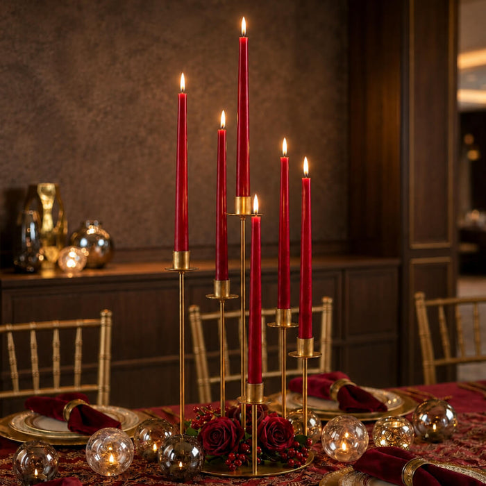 Lit red taper candles with gold stands and romantic table decor