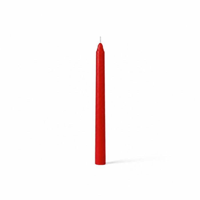 Unlit red taper candle standing on white background