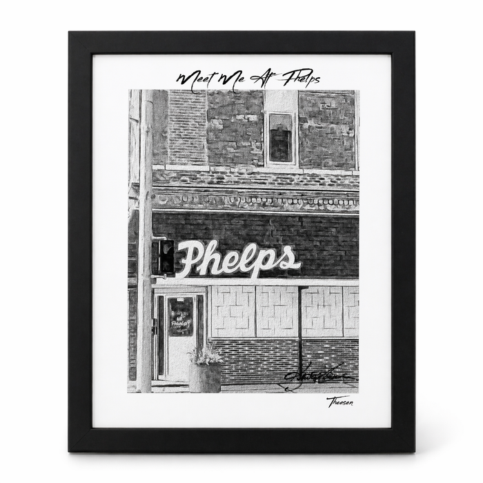 Framed black and white print of a building facade with 'Phelps' sign.