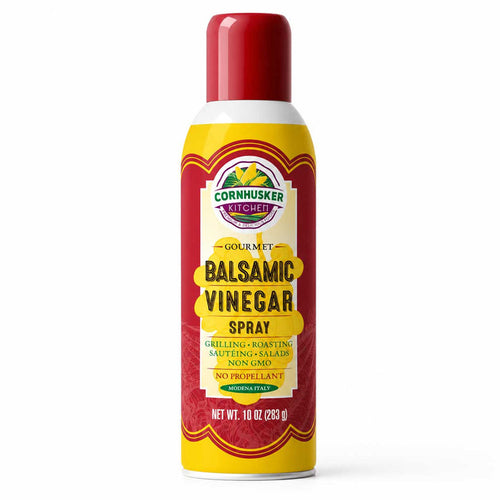 A 10 oz can of Cornhusker Kitchen Gourmet Balsamic Vinegar Spray, featuring a red cap, yellow and red label, and white base on a clean white background.