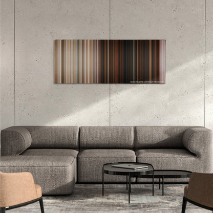 Superbad color palette canvas on a concrete wall above a gray sectional sofa