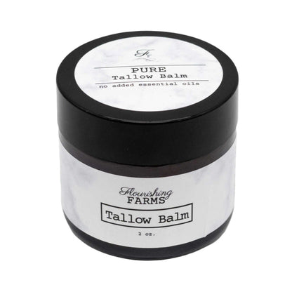 Tallow balm jar with black lid and white label on a white background